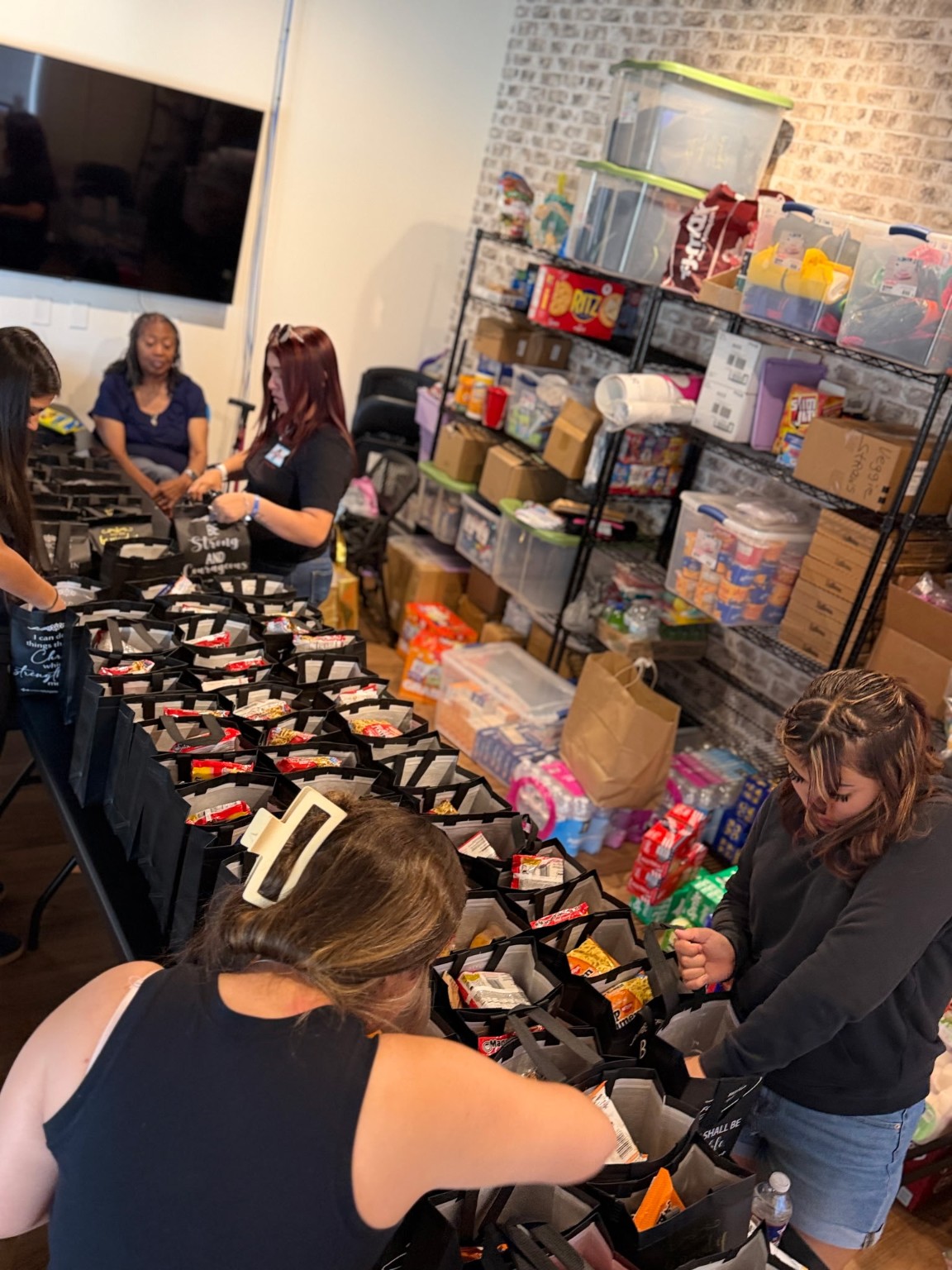 Volunteers packing food bags together
